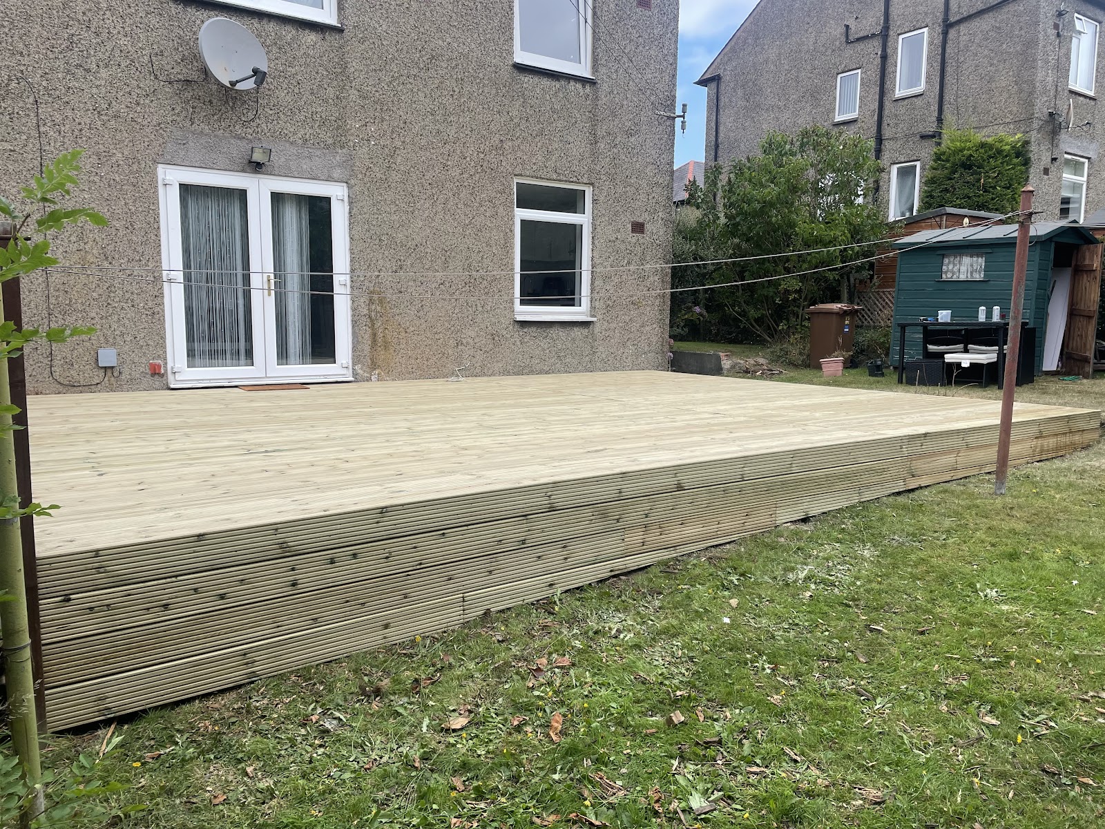 Large newly installed timber deck in a back garden