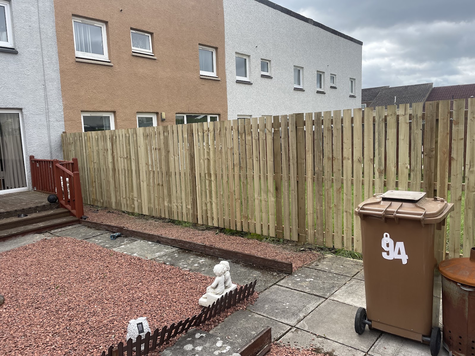 Long timber boundary fence installed along a front garden